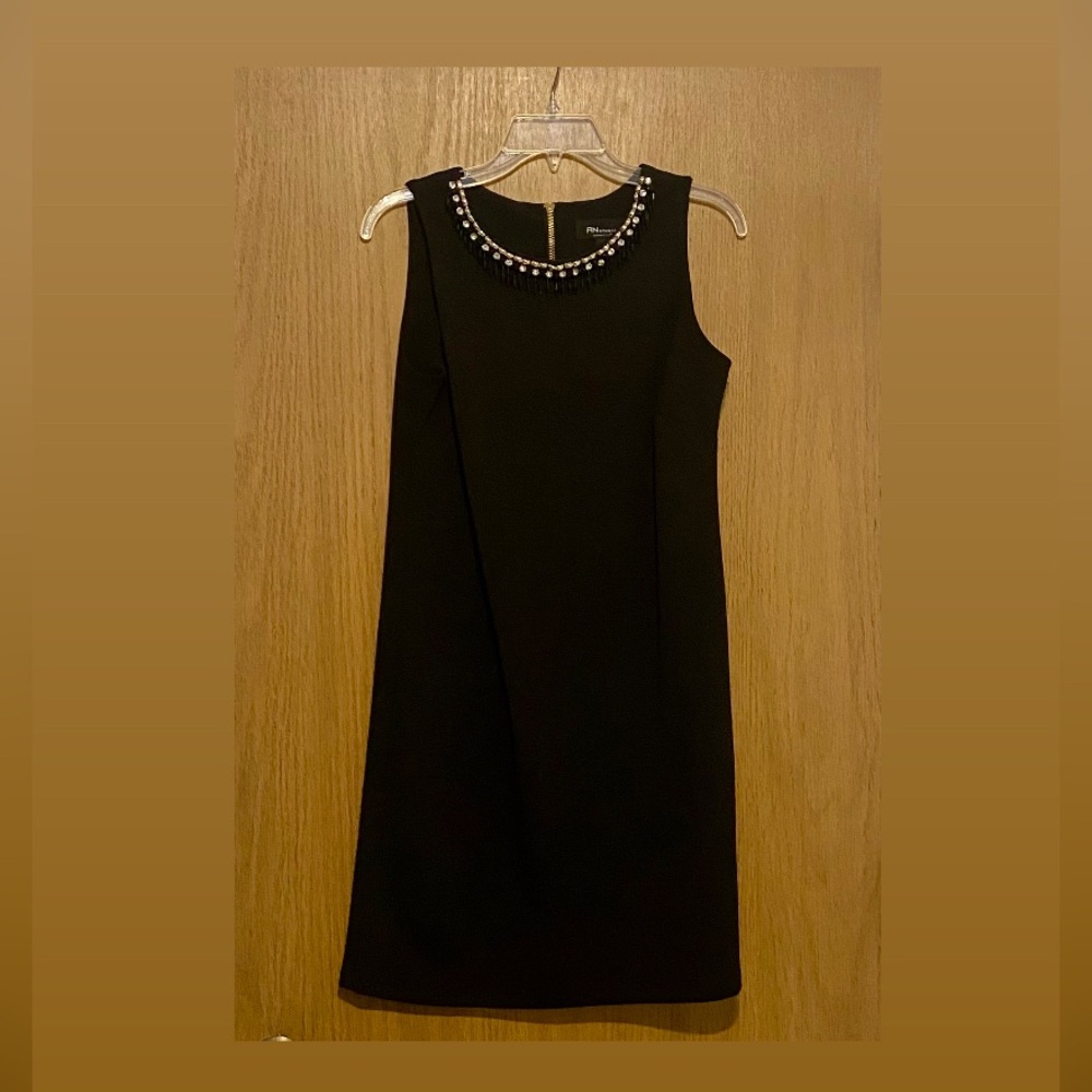 Mid length sleeveless Black Dress with neckline beaded accent. Worn once.